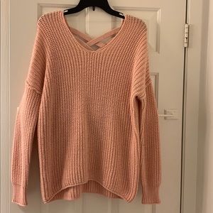 Pink thick knit sweater with crossing back detail
